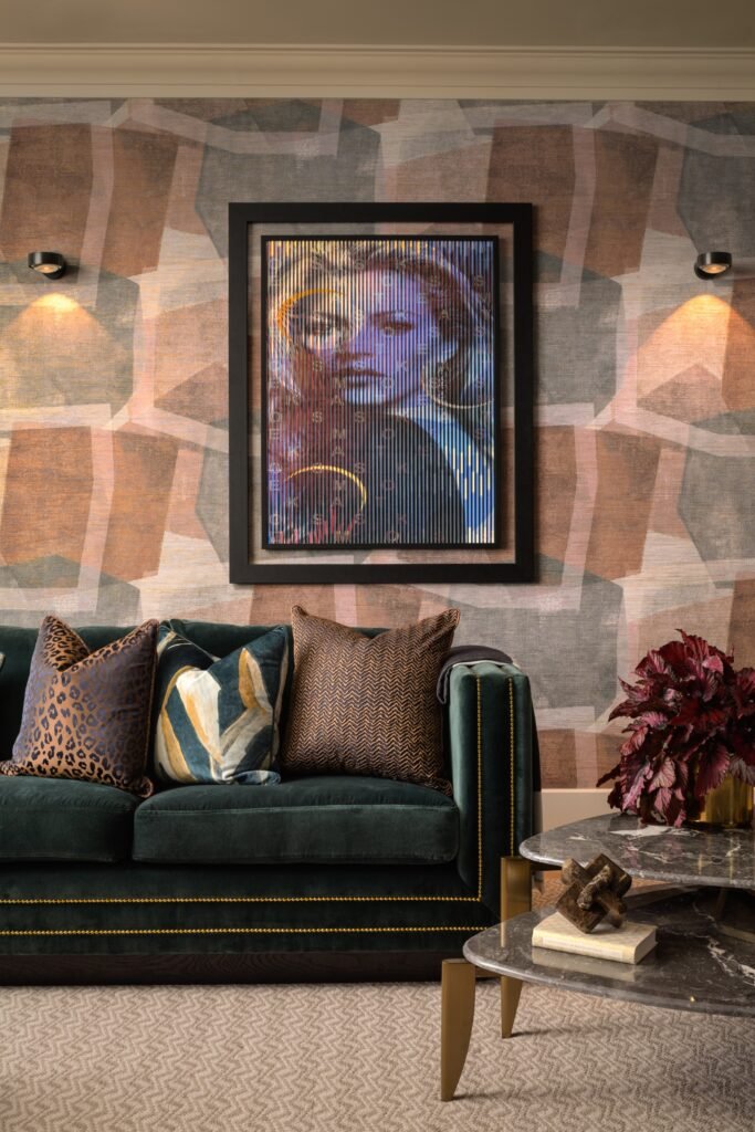 Elegant living room with dark green velvet sofa, modern geometric wallpaper, framed pop art, and marble coffee tables.